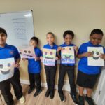 Group picture of boys showing their color emotions artwork.