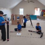 Students constructing new swing set for STEM & collaborative effort lesson.